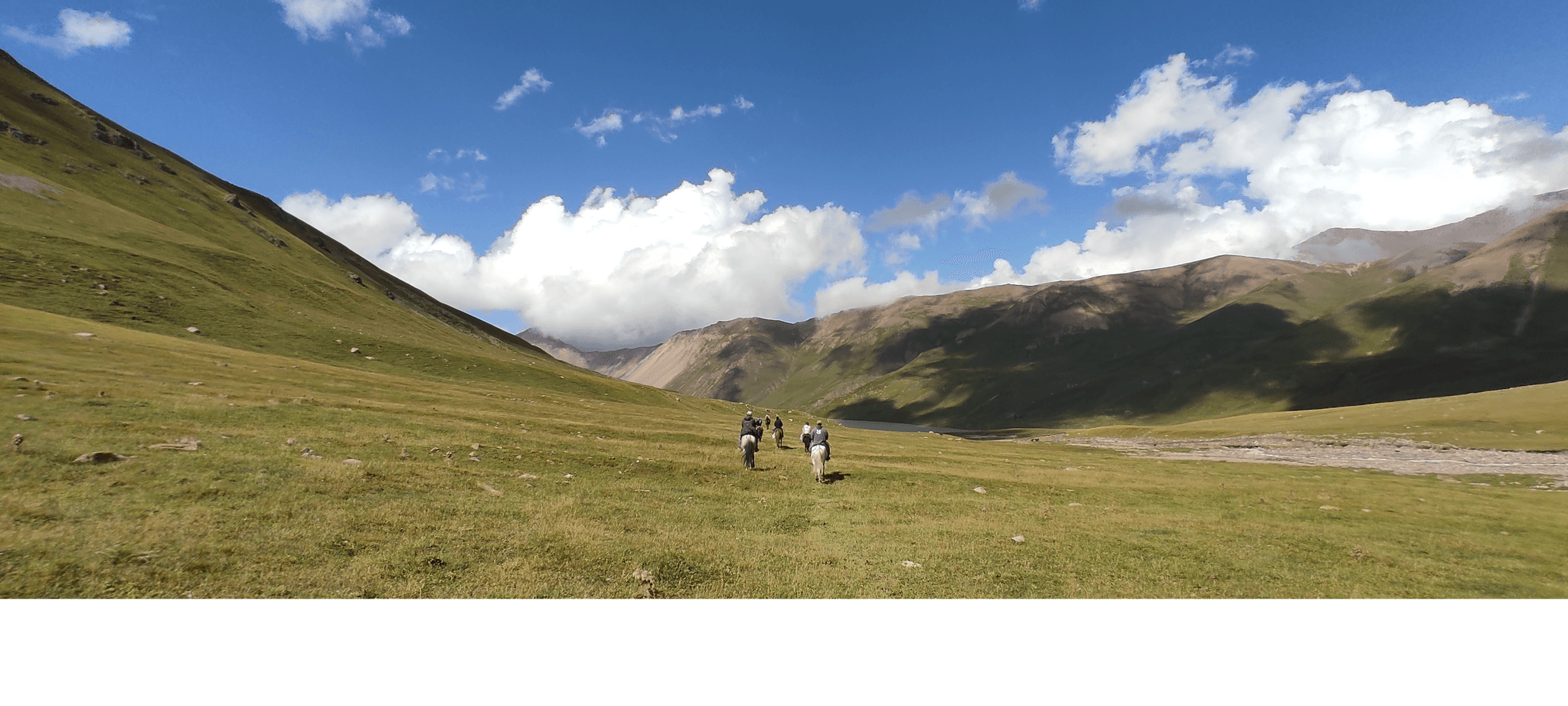 Horse riders in a Kyrgyz valley